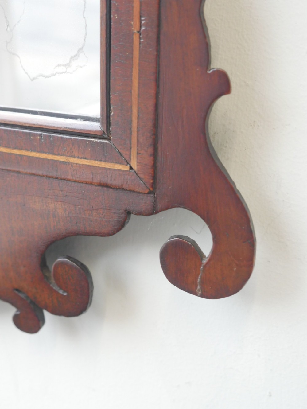 A petit Georgian mahogany wall mirror featuring a pierced fretwork frame topped with a gilded eagle crest. View IV