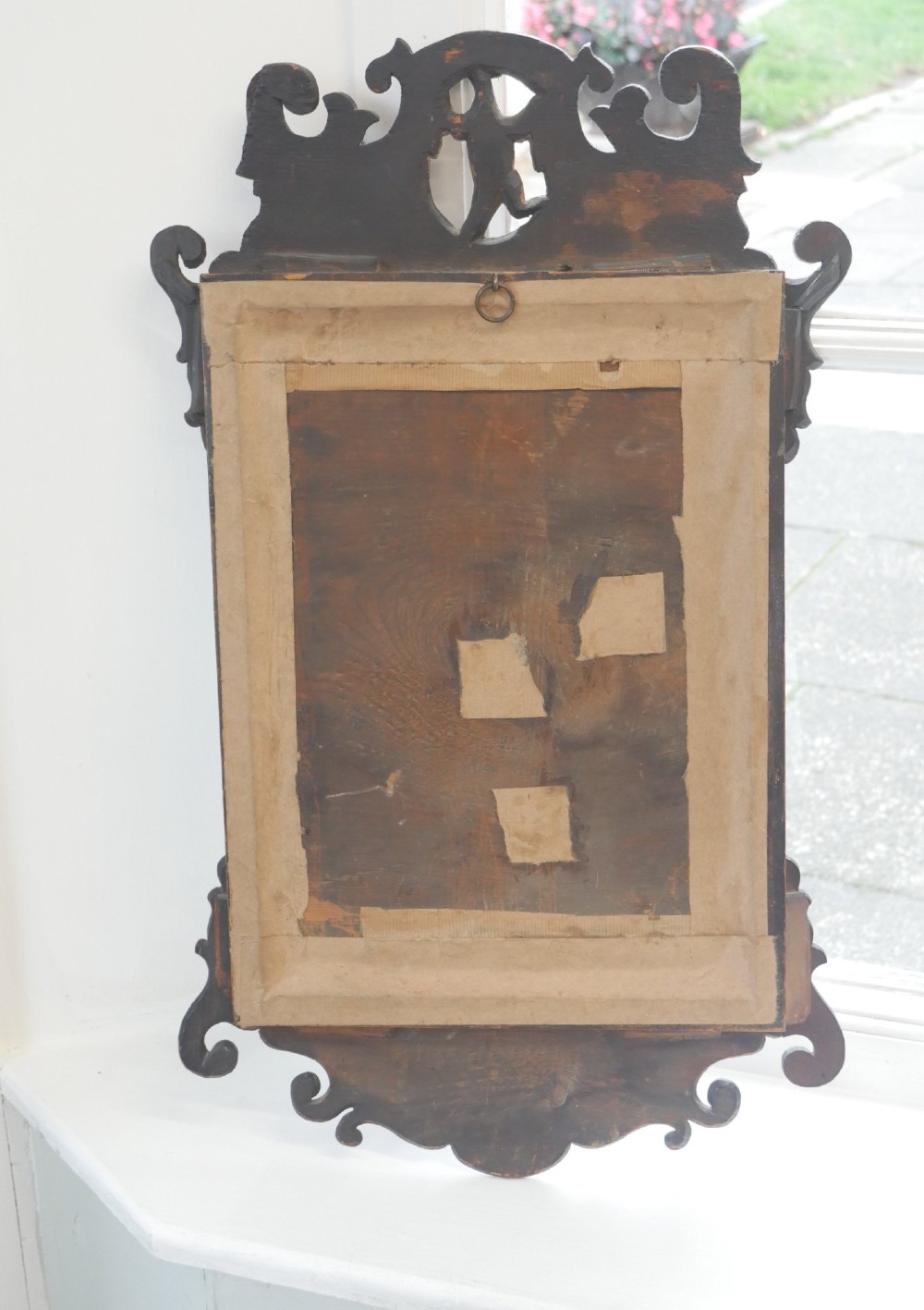 A petit Georgian mahogany wall mirror featuring a pierced fretwork frame topped with a gilded eagle crest. View VII