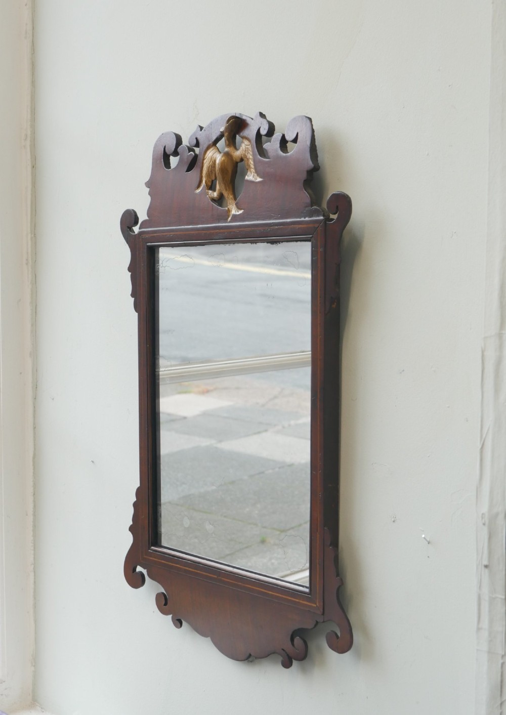 A petit Georgian mahogany wall mirror featuring a pierced fretwork frame topped with a gilded eagle crest. View VIII