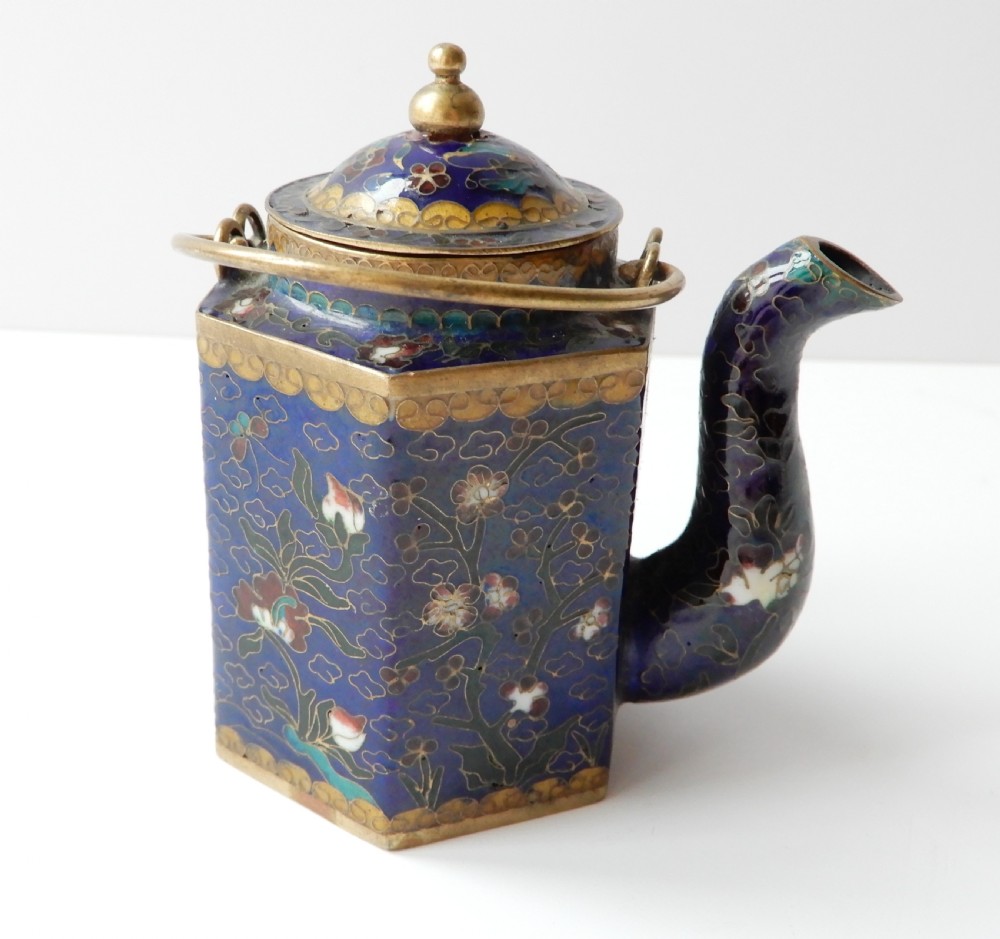 A hexagonal Chinese cloisonne enamel teapot featuring a navy blue body with floral motifs, gold wirework, and a fitted brass lid. View II