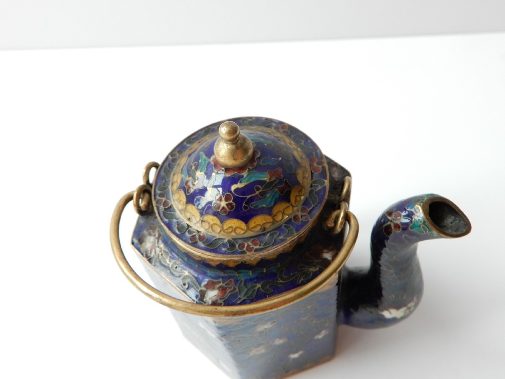 A hexagonal Chinese cloisonne enamel teapot featuring a navy blue body with floral motifs, gold wirework, and a fitted brass lid. View IV