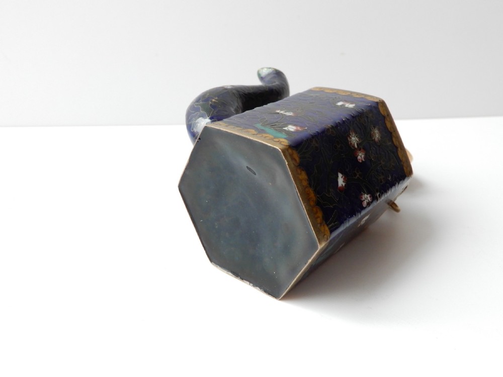 A hexagonal Chinese cloisonne enamel teapot featuring a navy blue body with floral motifs, gold wirework, and a fitted brass lid. View VI