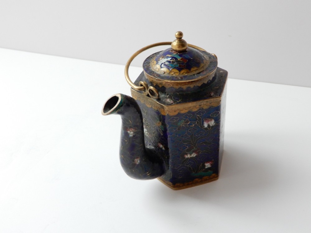 A hexagonal Chinese cloisonne enamel teapot featuring a navy blue body with floral motifs, gold wirework, and a fitted brass lid. View VII