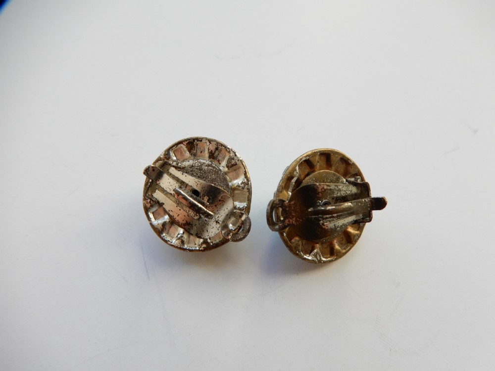 A pair of circular clip-on earrings featuring domed green Peking glass cabochons bordered by a halo of clear rhinestones in silver-tone settings. View III