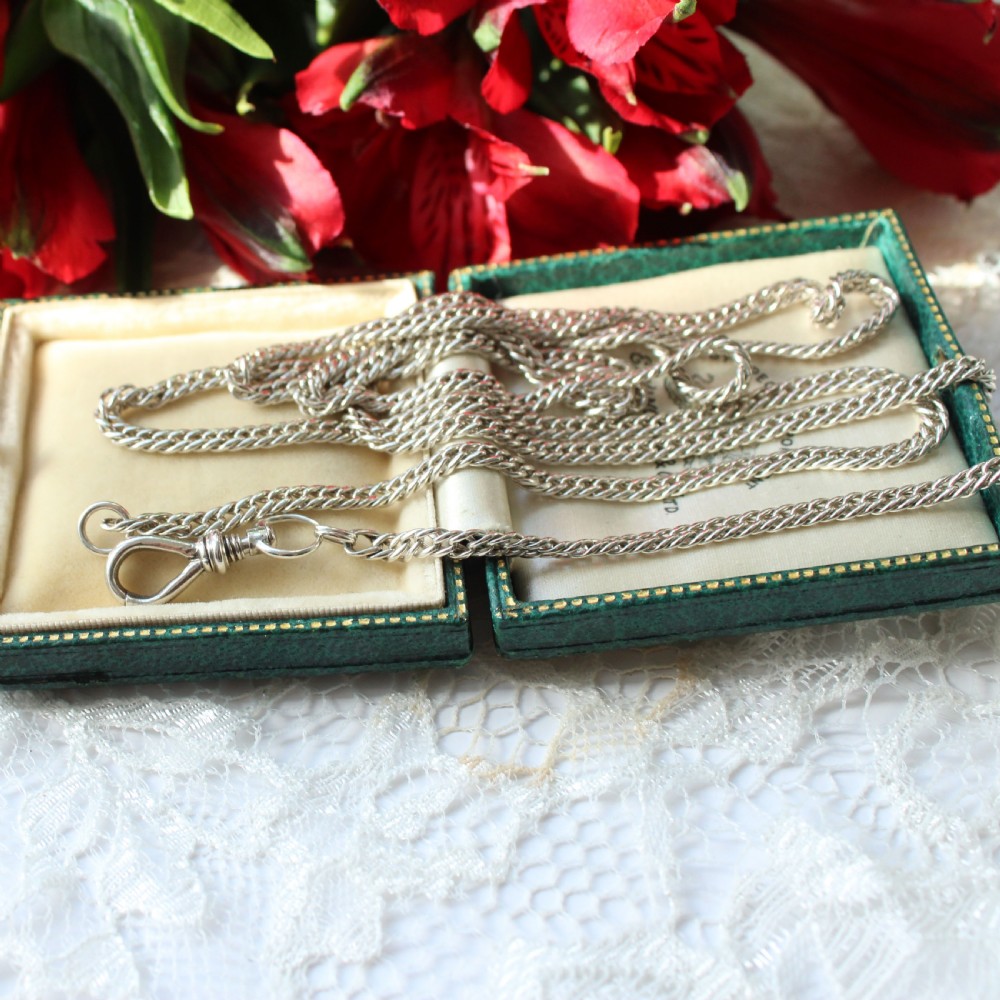 A long sterling silver pocket watch chain with detailed links and a classic screw-lock swivel clip. View IV