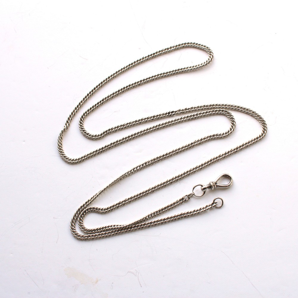 A long sterling silver pocket watch chain with detailed links and a classic screw-lock swivel clip. View VI