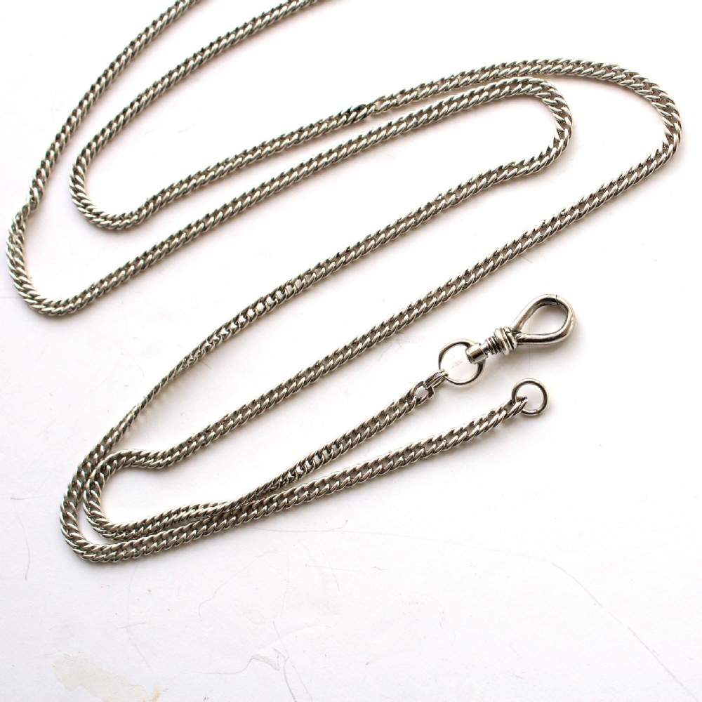 A long sterling silver pocket watch chain with detailed links and a classic screw-lock swivel clip. View VII