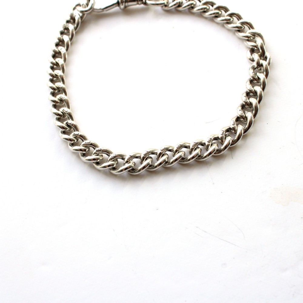Solid silver chain bracelet featuring interlinked links secured with a dog clip swivel clasp. View V