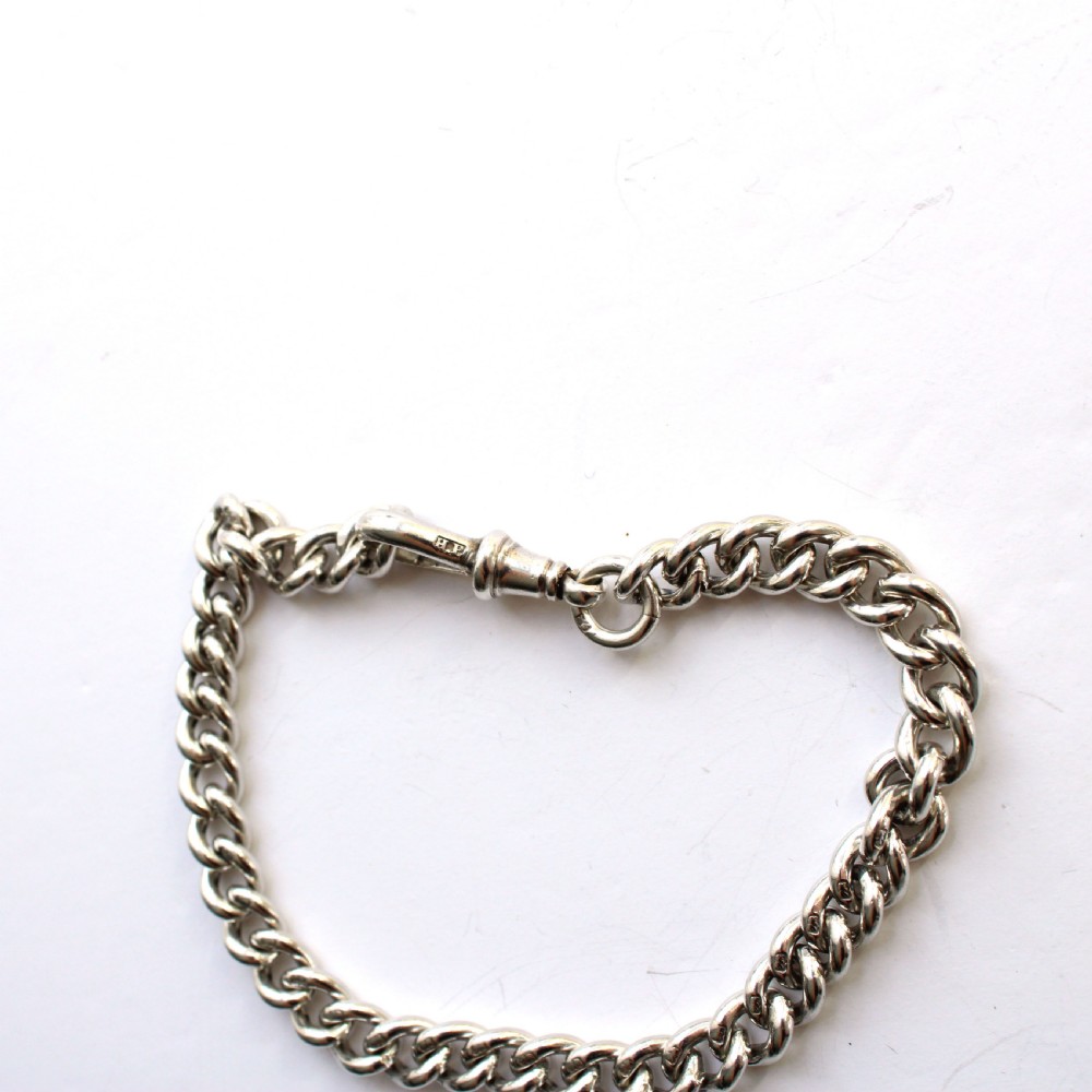 Solid silver chain bracelet featuring interlinked links secured with a dog clip swivel clasp. View VI