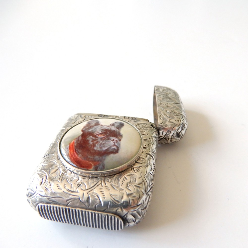 An antique Victorian sterling silver vesta case decorated with foliage engraving and a central circular enamel plaque depicting a French Bulldog. View VI