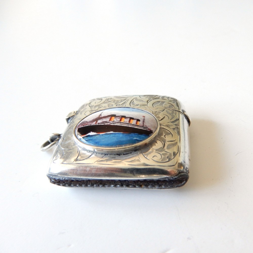 An Edwardian sterling silver vesta case with hand-engraved scrollwork and a central oval enamel depiction of a four-funnel ocean liner. View III
