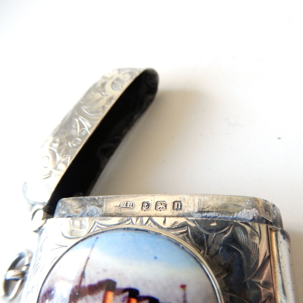 An Edwardian sterling silver vesta case with hand-engraved scrollwork and a central oval enamel depiction of a four-funnel ocean liner. View IV