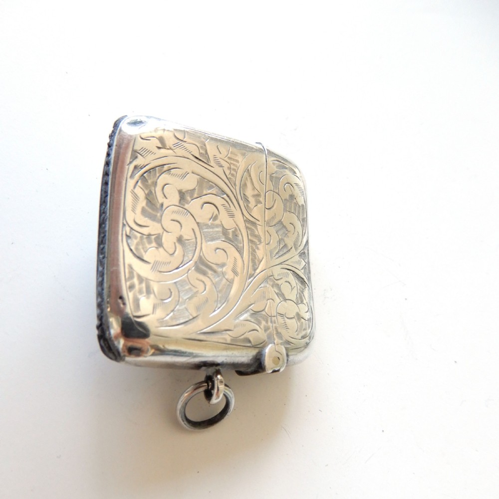 An Edwardian sterling silver vesta case with hand-engraved scrollwork and a central oval enamel depiction of a four-funnel ocean liner. View VI