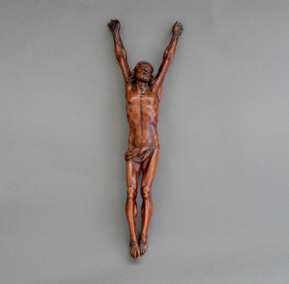 A hand carved fruitwood corpus figure from the 18th century
