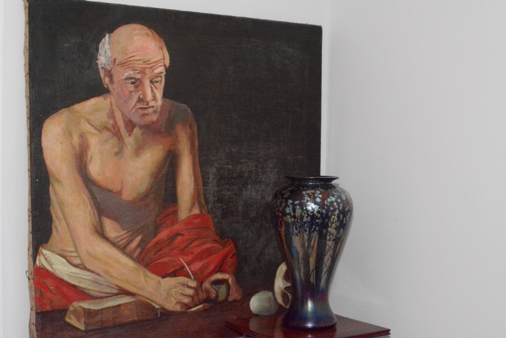 An oil painting on canvas depicting Saint Jerome writing in a book beside a human skull and stone against a dark background. View VI