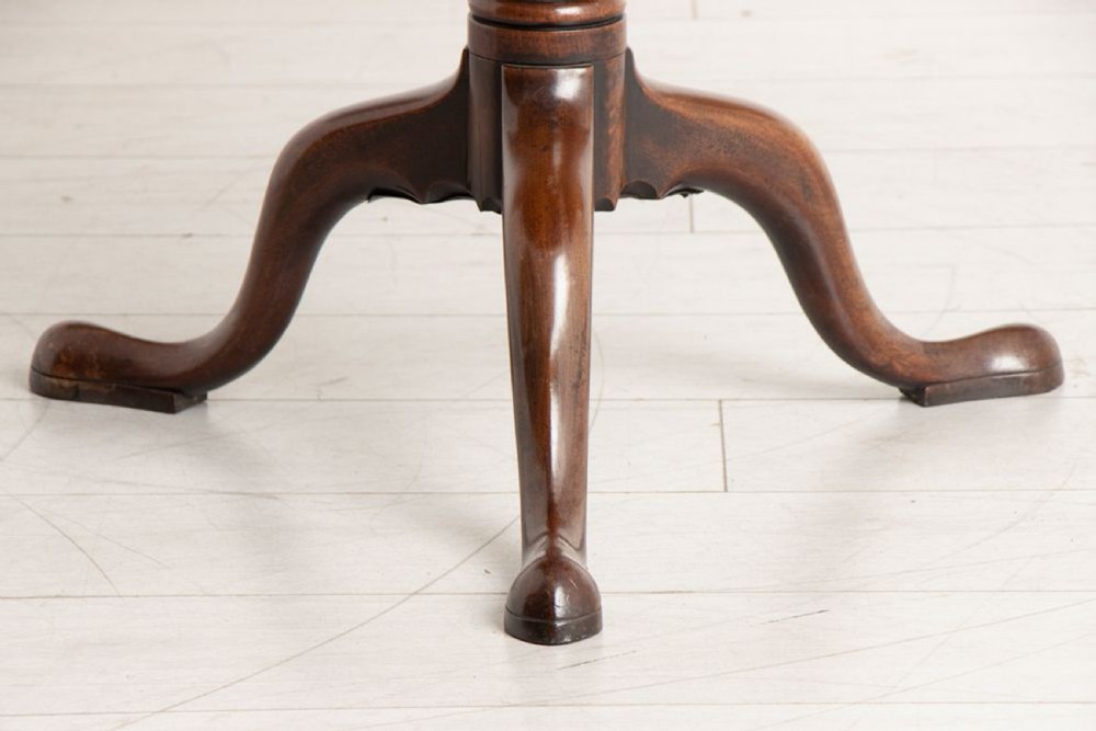 An eighteenth-century circular mahogany tilt-top table featuring a birdcage mechanism, turned central stem, and tripod cabriole legs. View V