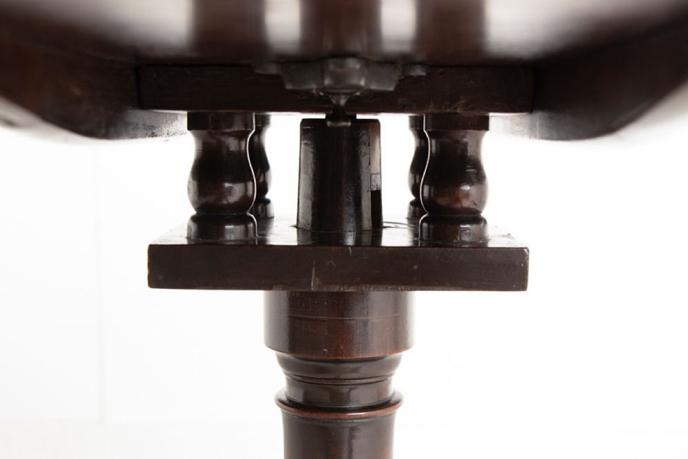 An eighteenth-century circular mahogany tilt-top table featuring a birdcage mechanism, turned central stem, and tripod cabriole legs. View VIII