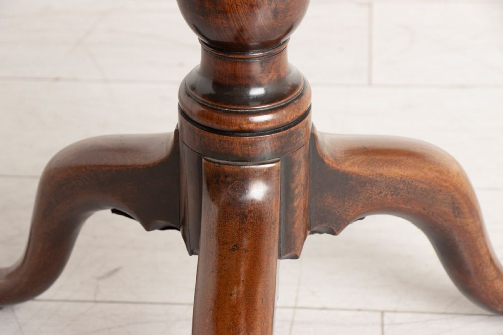 An eighteenth-century circular mahogany tilt-top table featuring a birdcage mechanism, turned central stem, and tripod cabriole legs. View IX