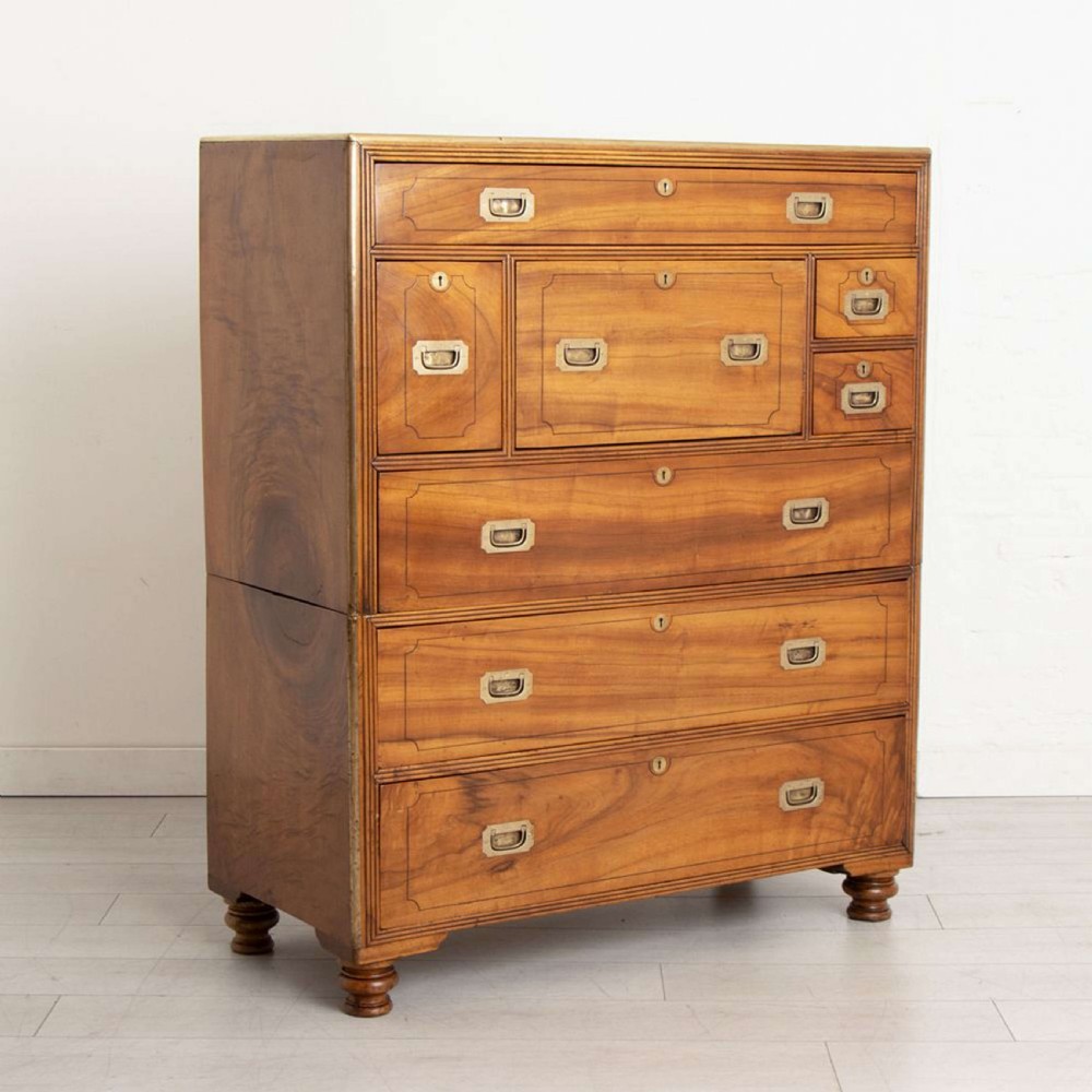 An antique 19th-century camphorwood military campaign secretaire chest featuring flush brass handles, geometric drawer borders, and turned feet. View III