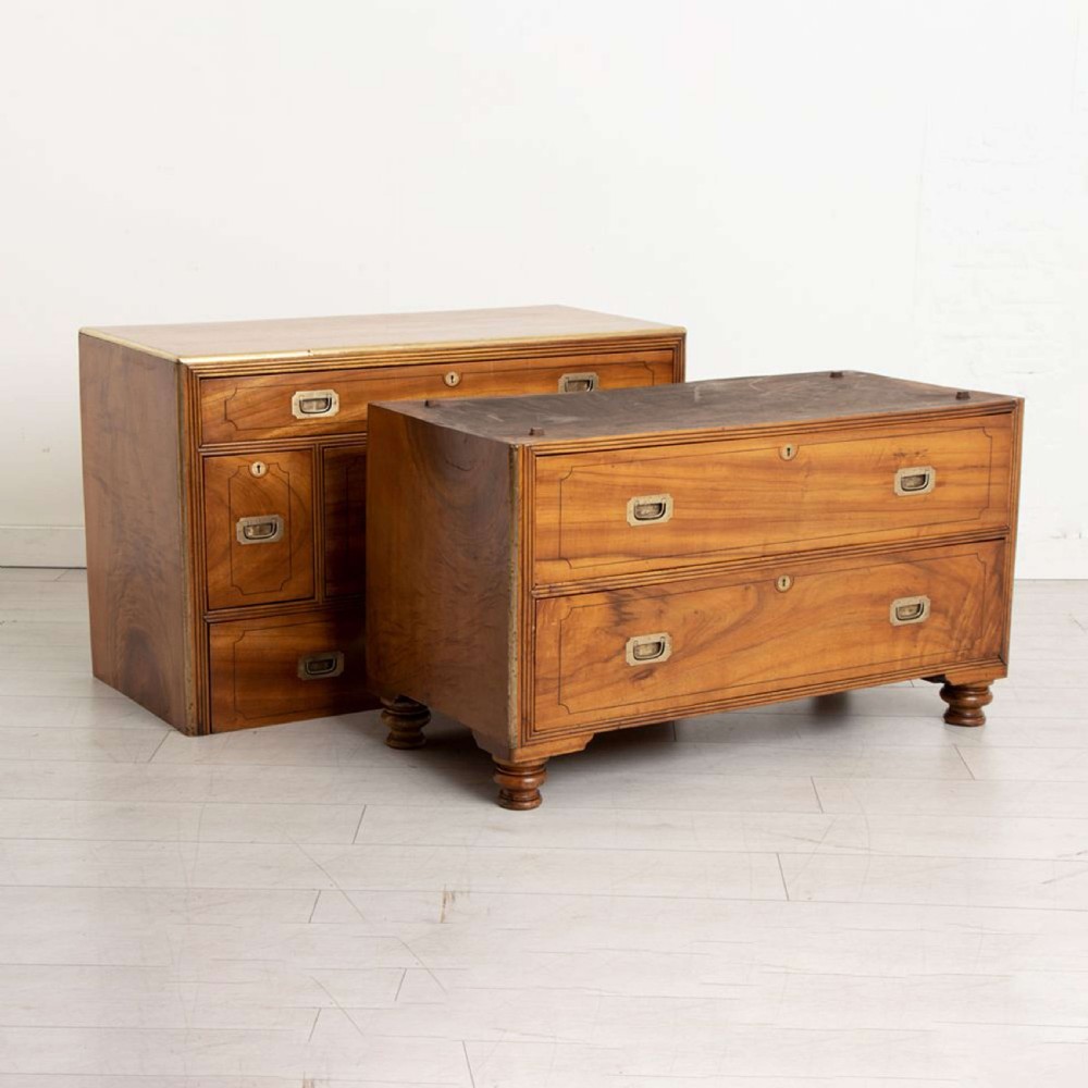 An antique 19th-century camphorwood military campaign secretaire chest featuring flush brass handles, geometric drawer borders, and turned feet. View VI