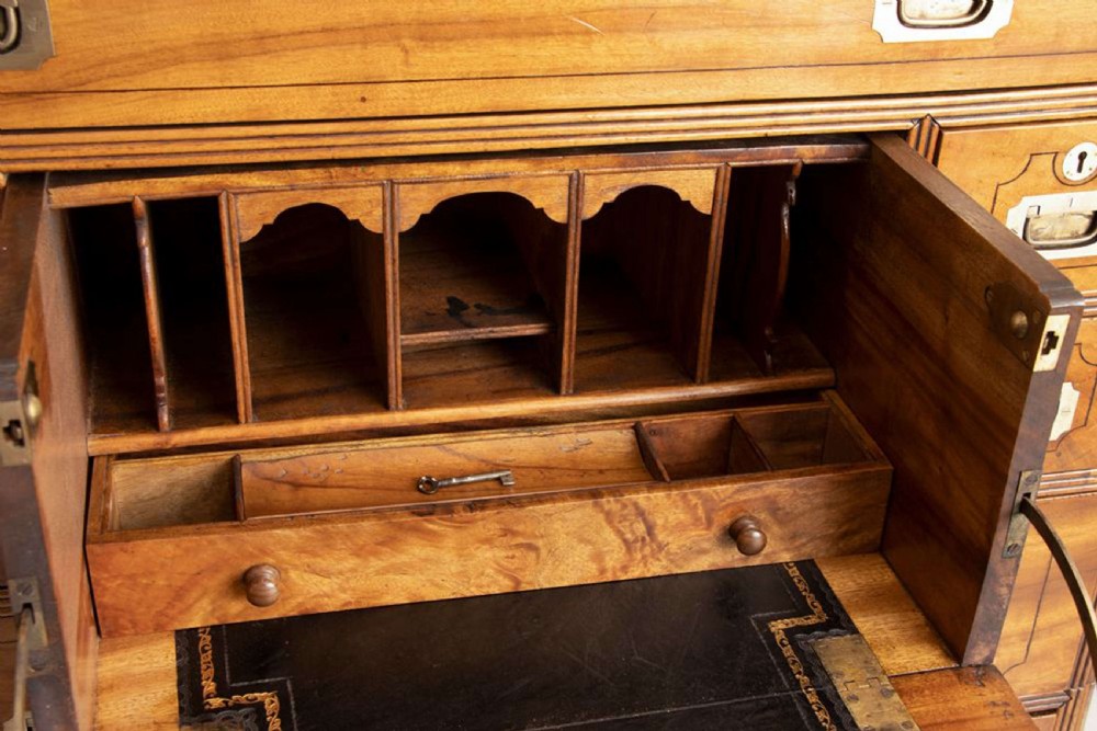 An antique 19th-century camphorwood military campaign secretaire chest featuring flush brass handles, geometric drawer borders, and turned feet. View XIII