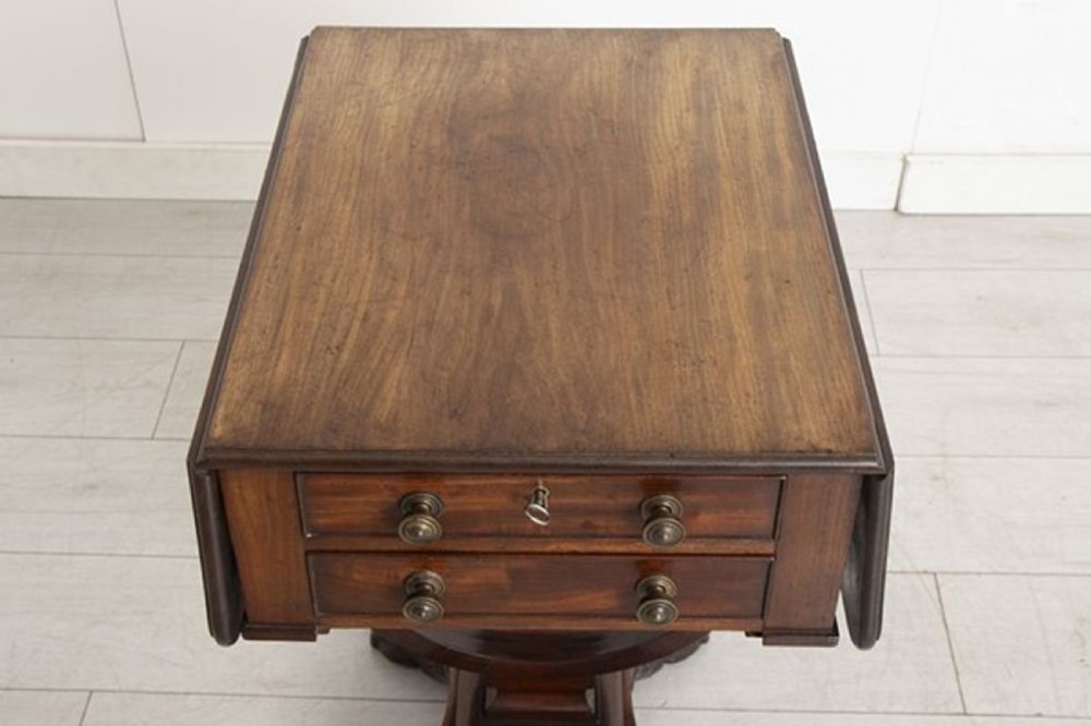 A small Georgian mahogany side table featuring drop leaves, two front drawers, a curved U-shaped support, and carved claw feet. View VII