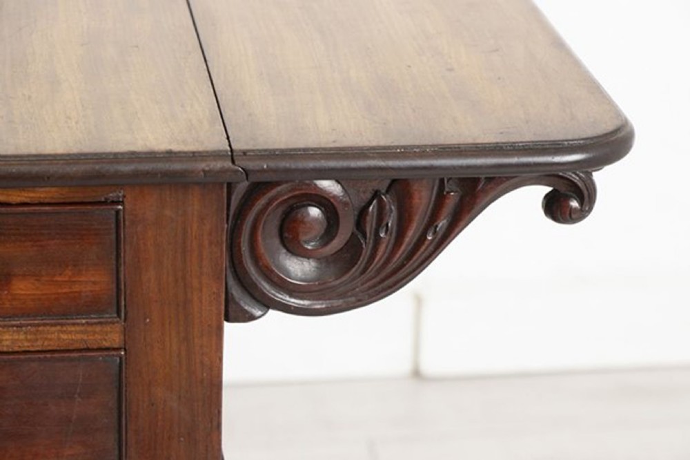 A small Georgian mahogany side table featuring drop leaves, two front drawers, a curved U-shaped support, and carved claw feet. View XV