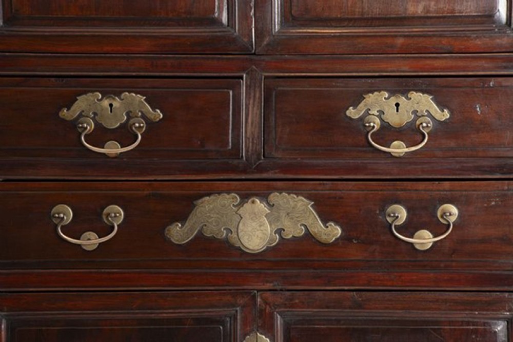 A tall late nineteenth-century Chinese dark brown lacquered wooden cabinet featuring panelled doors, multiple drawers, and decorative brass hardware plates. View V
