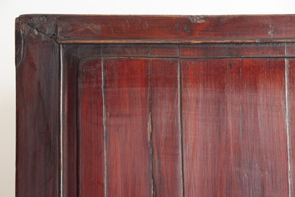 A tall late nineteenth-century Chinese dark brown lacquered wooden cabinet featuring panelled doors, multiple drawers, and decorative brass hardware plates. View X