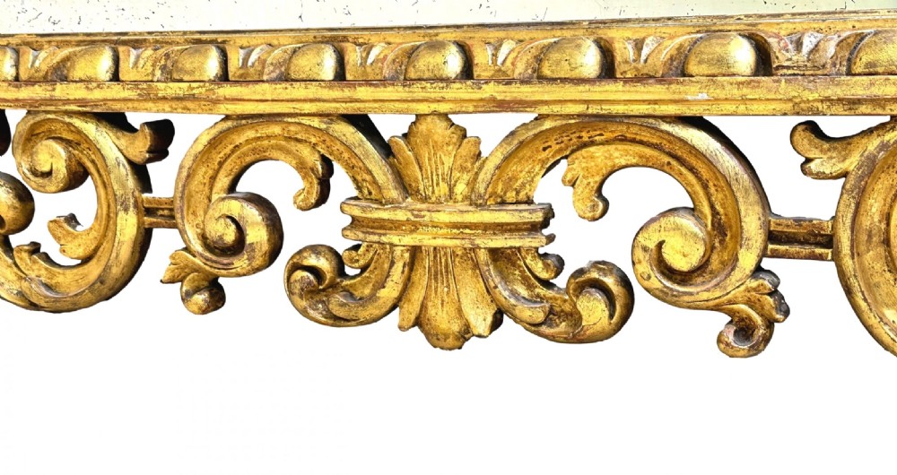 A late 18th-century Italian rectangular wall mirror featuring an intricate carved openwork giltwood frame with scroll motifs and acanthus leaf details. View II