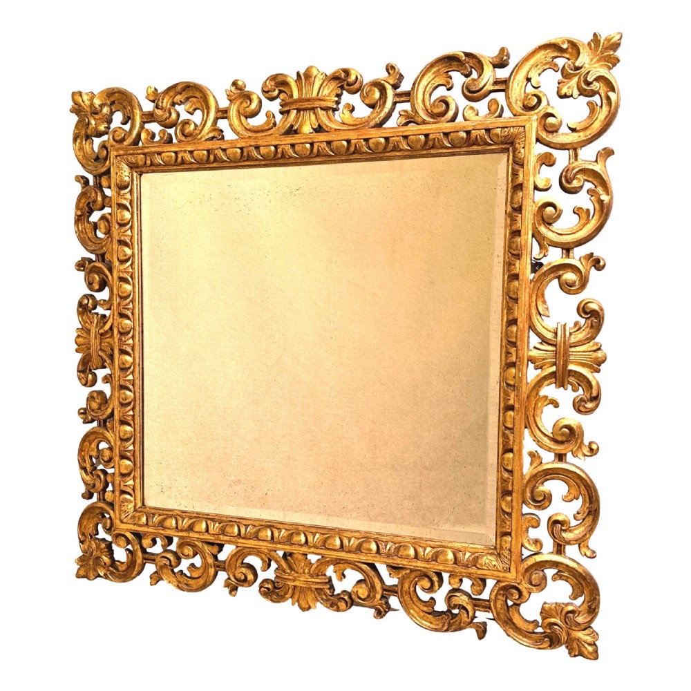 A late 18th-century Italian rectangular wall mirror featuring an intricate carved openwork giltwood frame with scroll motifs and acanthus leaf details. View III