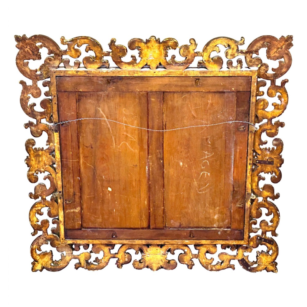A late 18th-century Italian rectangular wall mirror featuring an intricate carved openwork giltwood frame with scroll motifs and acanthus leaf details. View X
