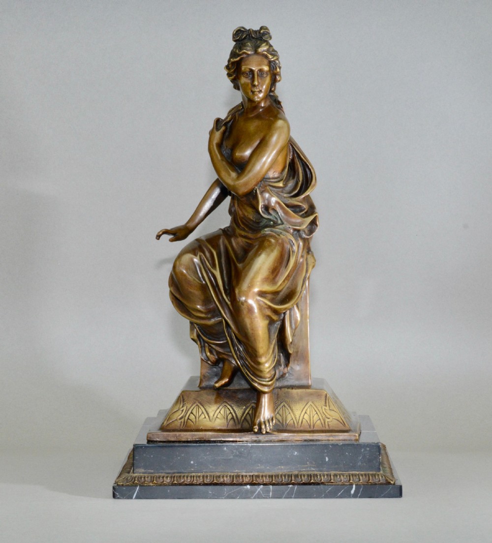 A neoclassical style bronze lady on detailed plinth base