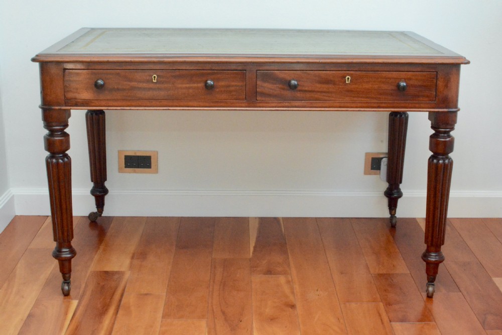 An early Victorian fiddle back mahogany two Drawer Circa 1860 reeded legged leather inset writing table