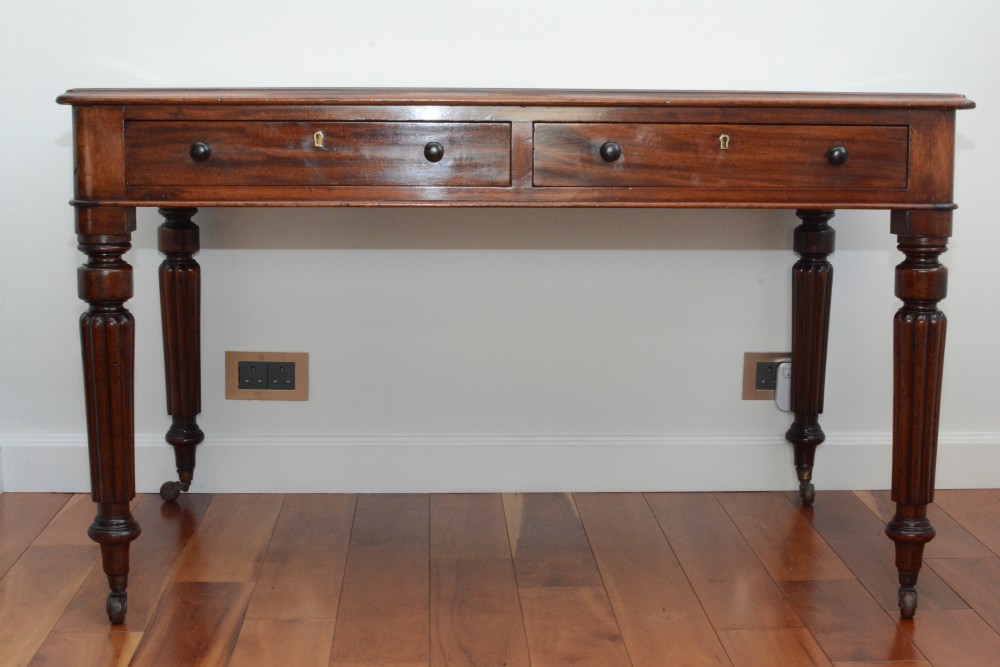 An early Victorian fiddle back mahogany two Drawer Circa 1860 reeded legged leather inset writing table View IV