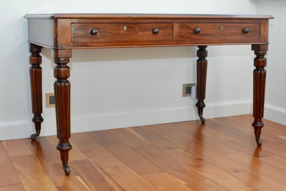 An early Victorian fiddle back mahogany two Drawer Circa 1860 reeded legged leather inset writing table View V