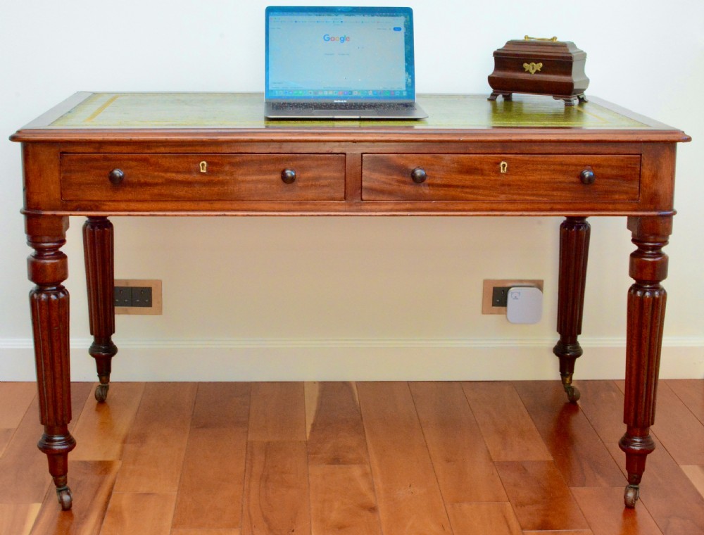 An early Victorian fiddle back mahogany two Drawer Circa 1860 reeded legged leather inset writing table View X