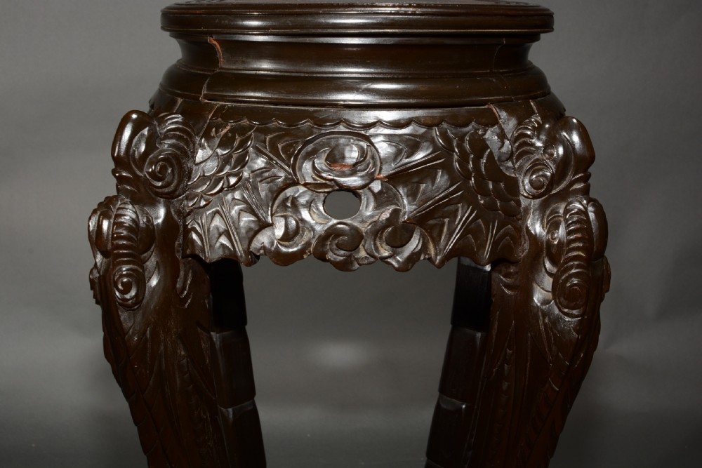 A pair of dark wood carved Asian plant stands featuring round inset tops, openwork aprons, cabriole legs, and lower circular shelves. View VI
