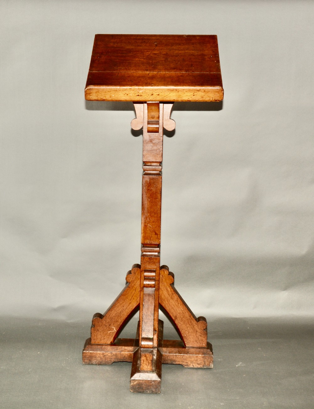 A Victorian carved oak church lectern featuring an angled reading ledge supported by a central column and a four-point braced base. View II