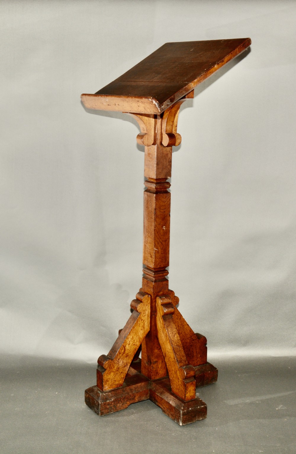 A Victorian carved oak church lectern featuring an angled reading ledge supported by a central column and a four-point braced base. View III