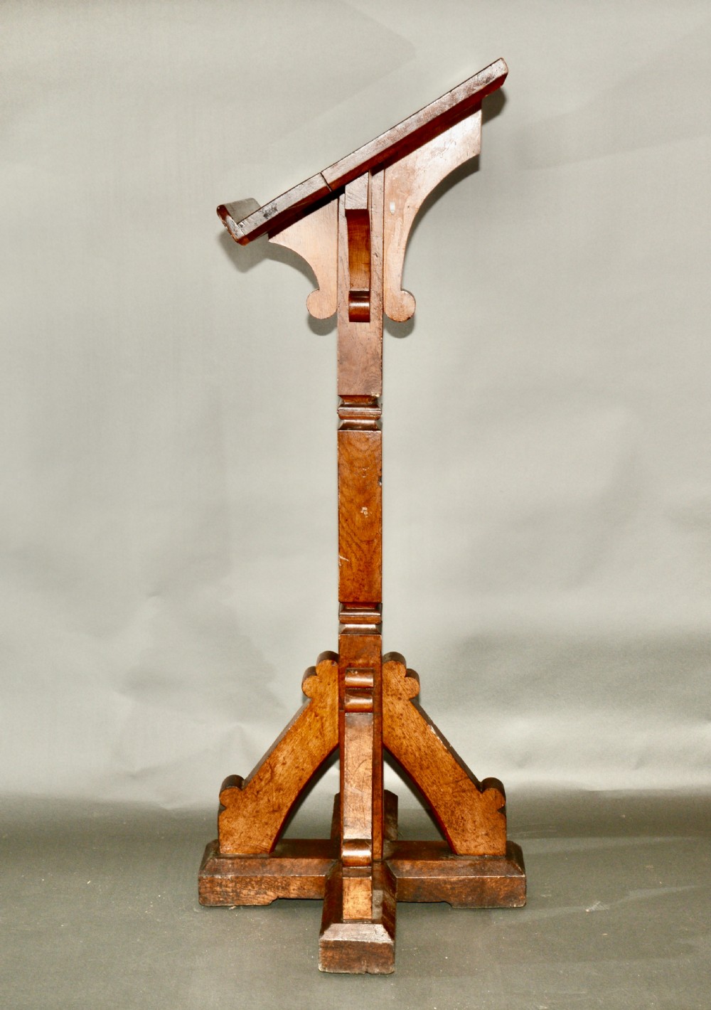 A Victorian carved oak church lectern featuring an angled reading ledge supported by a central column and a four-point braced base. View IV