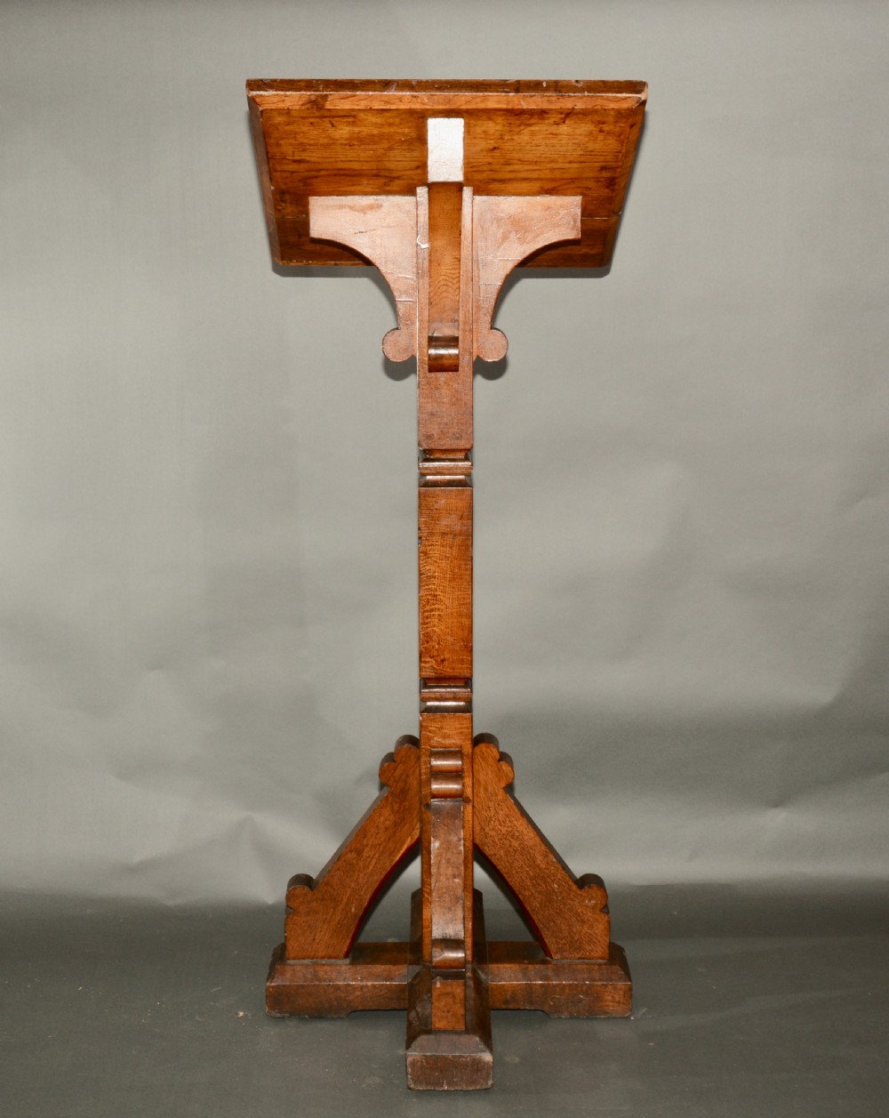 A Victorian carved oak church lectern featuring an angled reading ledge supported by a central column and a four-point braced base. View V