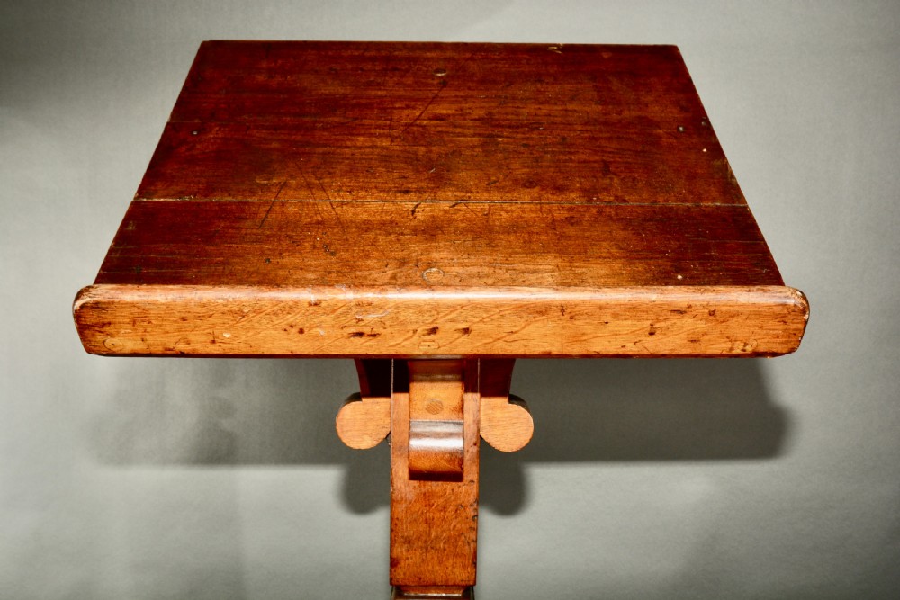 A Victorian carved oak church lectern featuring an angled reading ledge supported by a central column and a four-point braced base. View VII