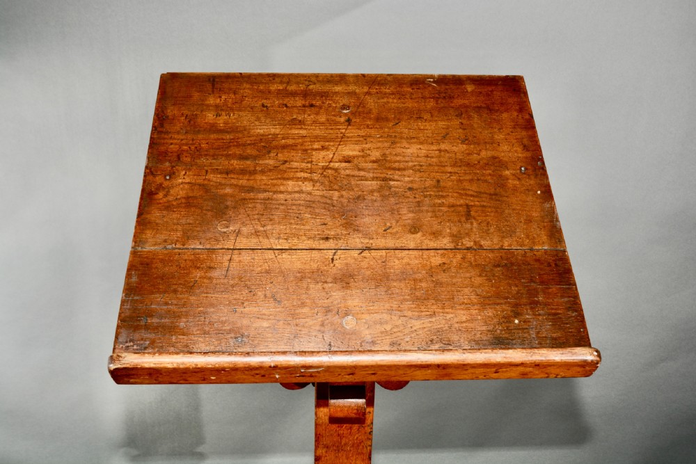 A Victorian carved oak church lectern featuring an angled reading ledge supported by a central column and a four-point braced base. View VIII