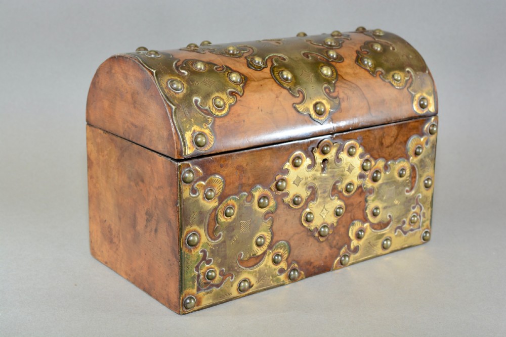 A Victorian dome-topped figured walnut stationery box featuring ornate pierced brass mounts and studs. View II
