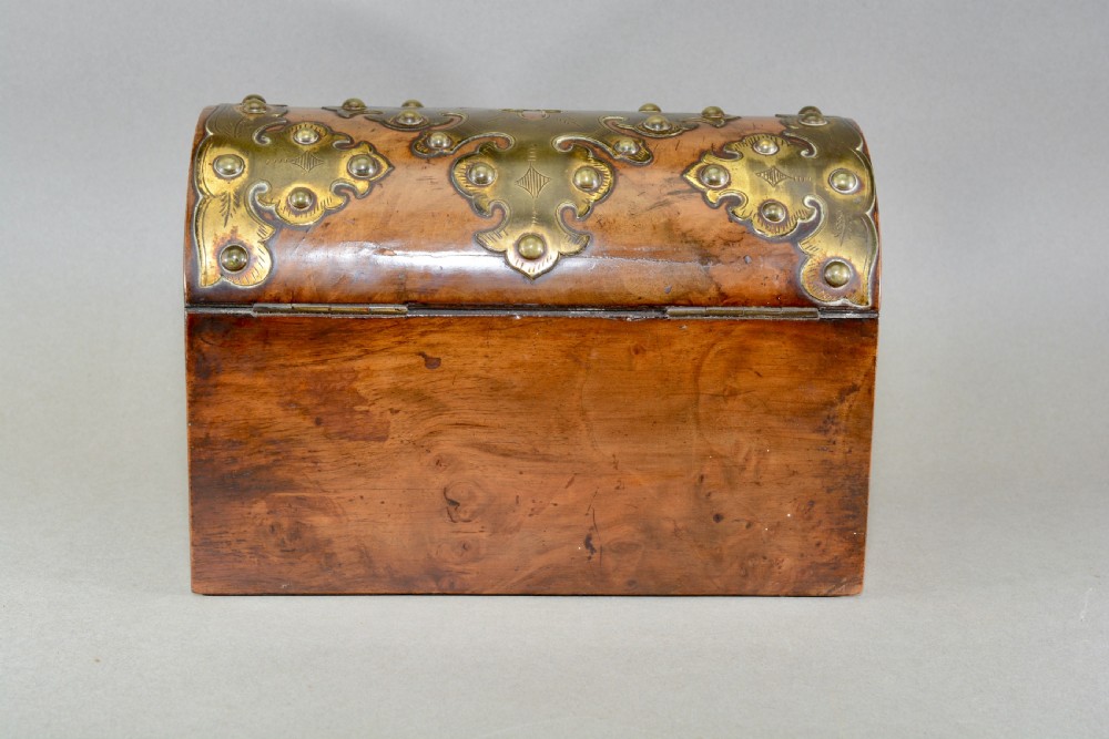 A Victorian dome-topped figured walnut stationery box featuring ornate pierced brass mounts and studs. View III