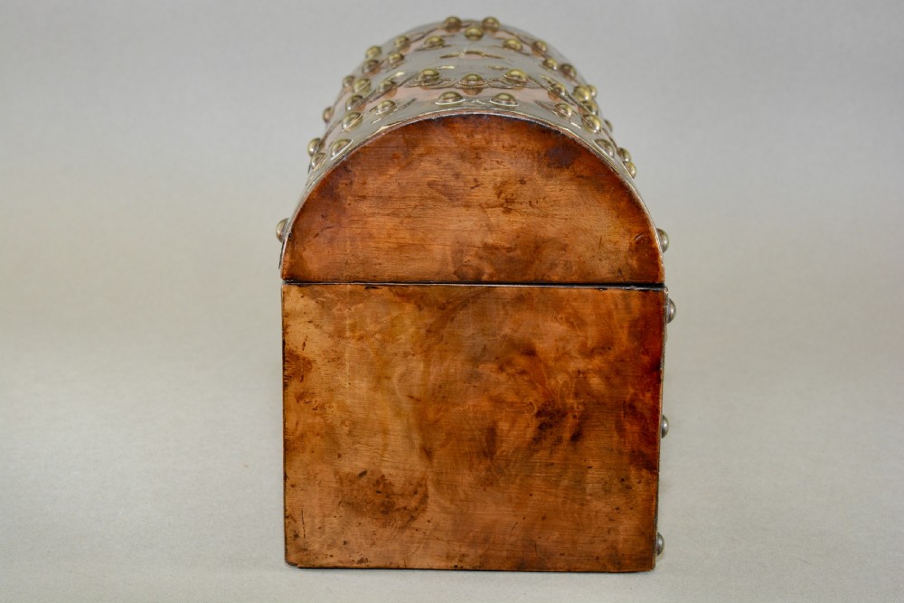 A Victorian dome-topped figured walnut stationery box featuring ornate pierced brass mounts and studs. View V