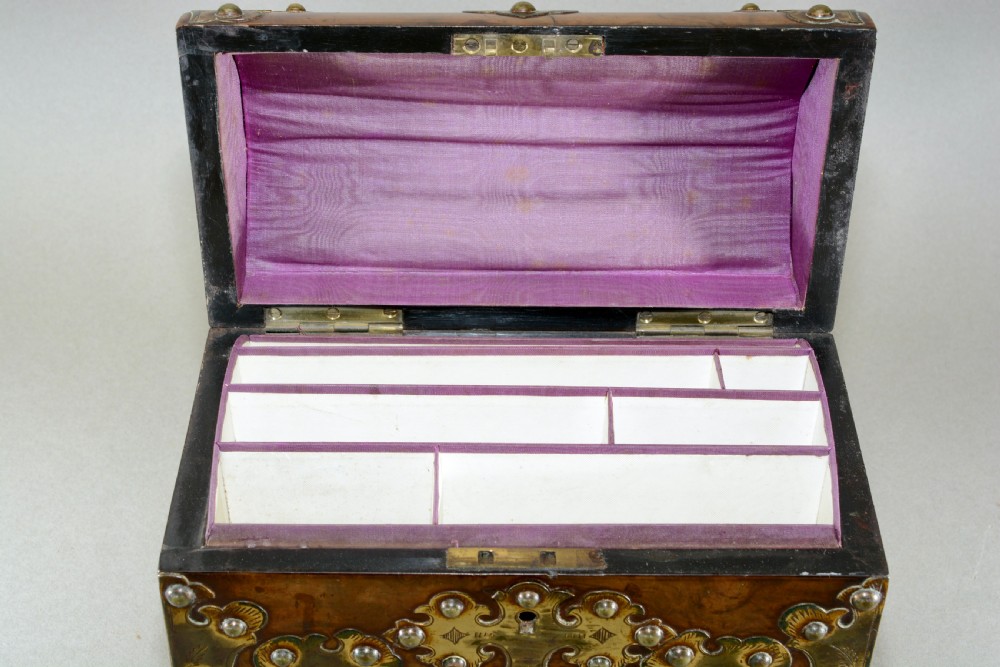 A Victorian dome-topped figured walnut stationery box featuring ornate pierced brass mounts and studs. View VII