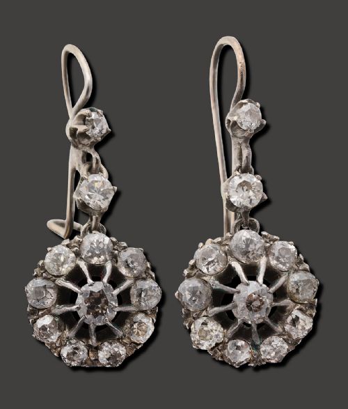 fig 1. A pair of antique diamond drop earrings featuring old European cut diamonds set in round openwork cluster drops suspended from hook fittings.