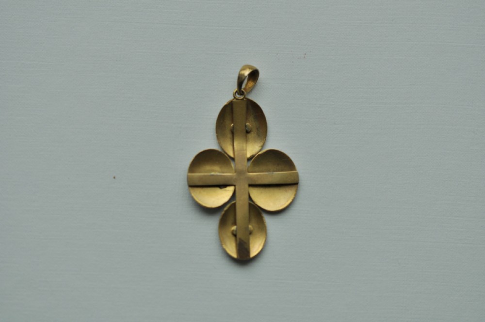An antique 22ct gold pendant featuring four oval green enamelled medallions with profile portrait miniatures arranged in a cross formation. View II